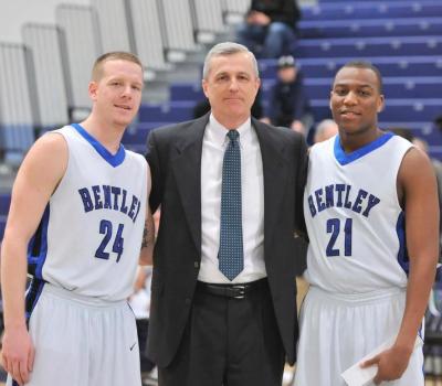 Coach Jay Lawson with his two seniors, Mike Topercer (24) and Mikerson Laurent