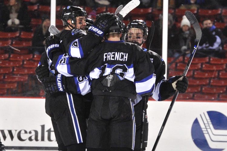 Max French and co. celebrate Bentley's 1st goal at Frozen Fenway Thursday night.