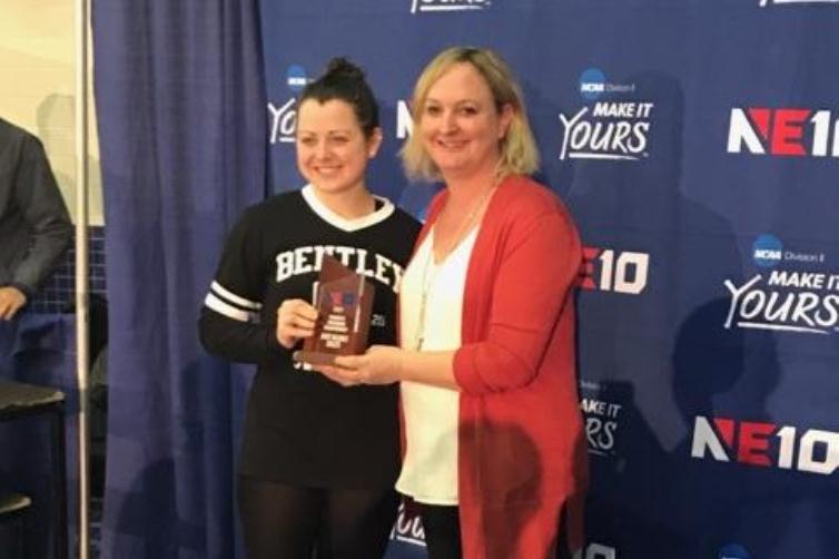 Emily Niemiec receives the NE10 Women's Swimmer of the Meet award from commissioner Julie Ruppert