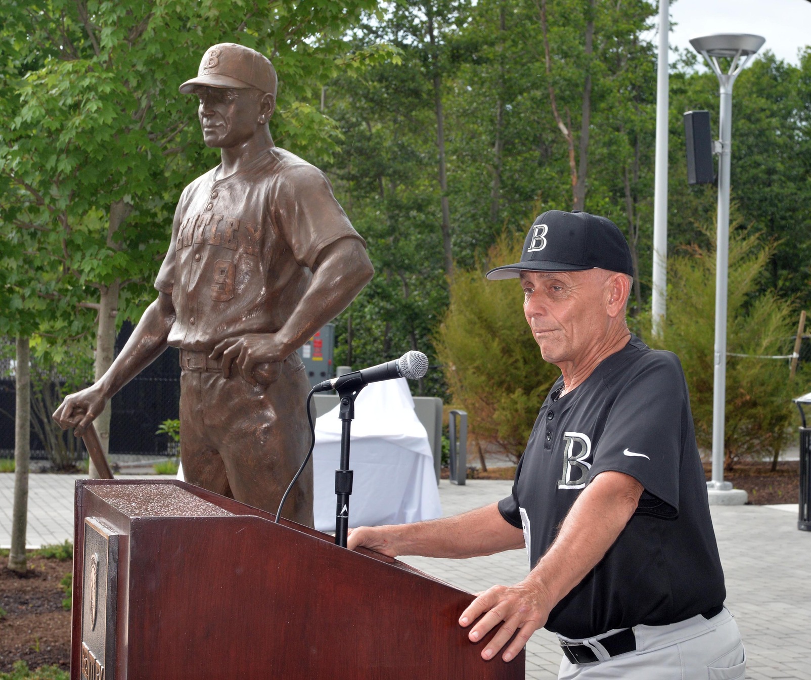 Coach DeFelice, along side the statue
