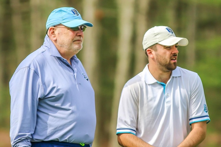 Senior Cal Meyers with Bentley golf coach Mickey Herron