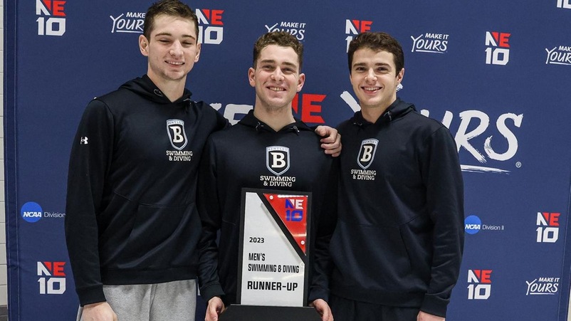 Bentley men's swim captains Ryan Looney, Michael Motisi and Anthony Vizental with the second-place trophy.